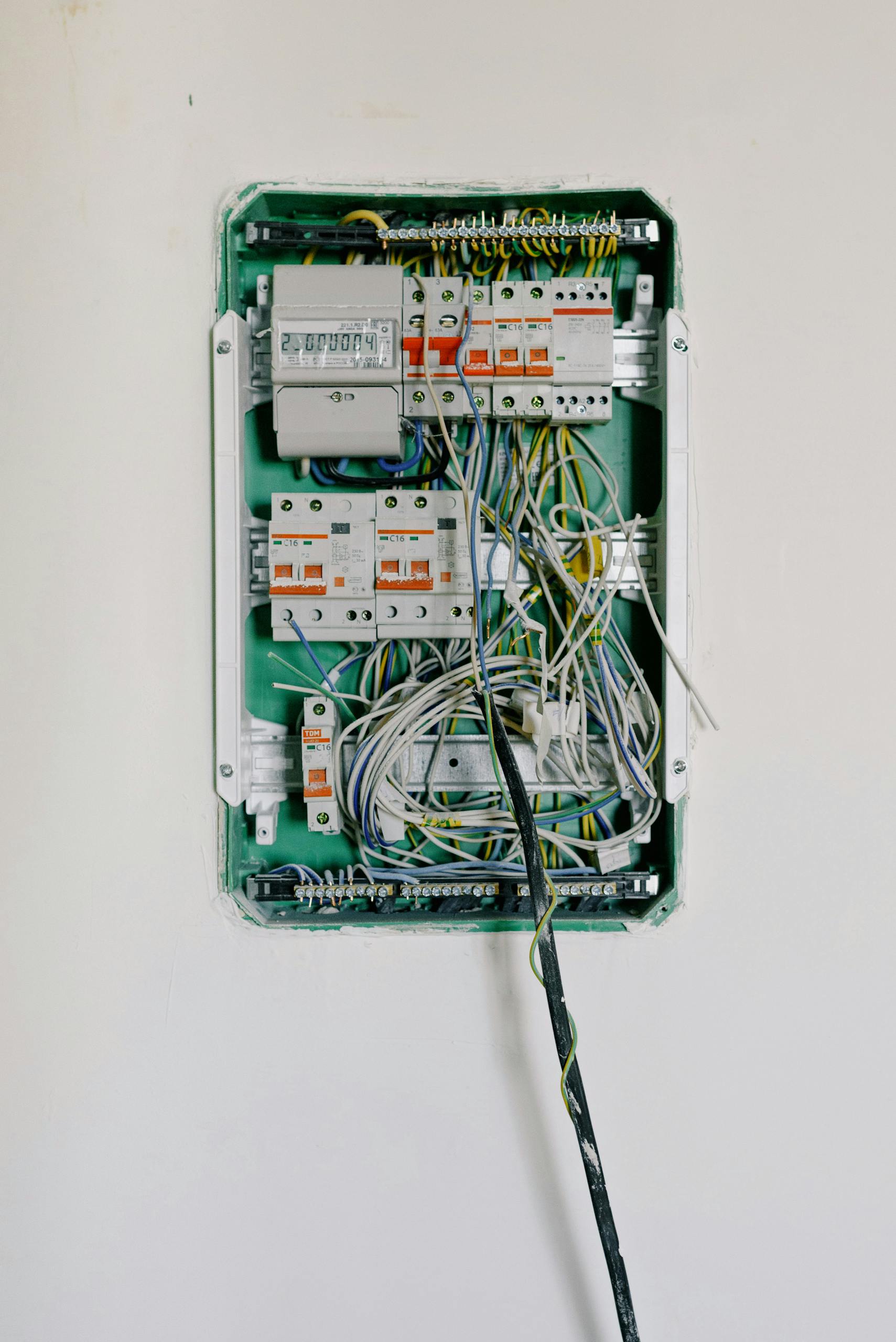 detailed view of an open electrical circuit box with complex wiring and circuit breakers 5767595 scaled 1